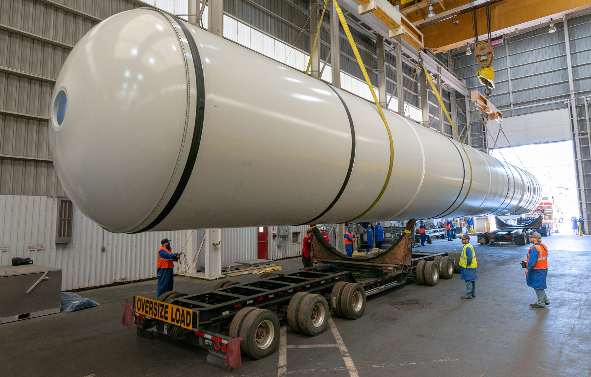 a solid rocket booster is loaded on an oversize trailer