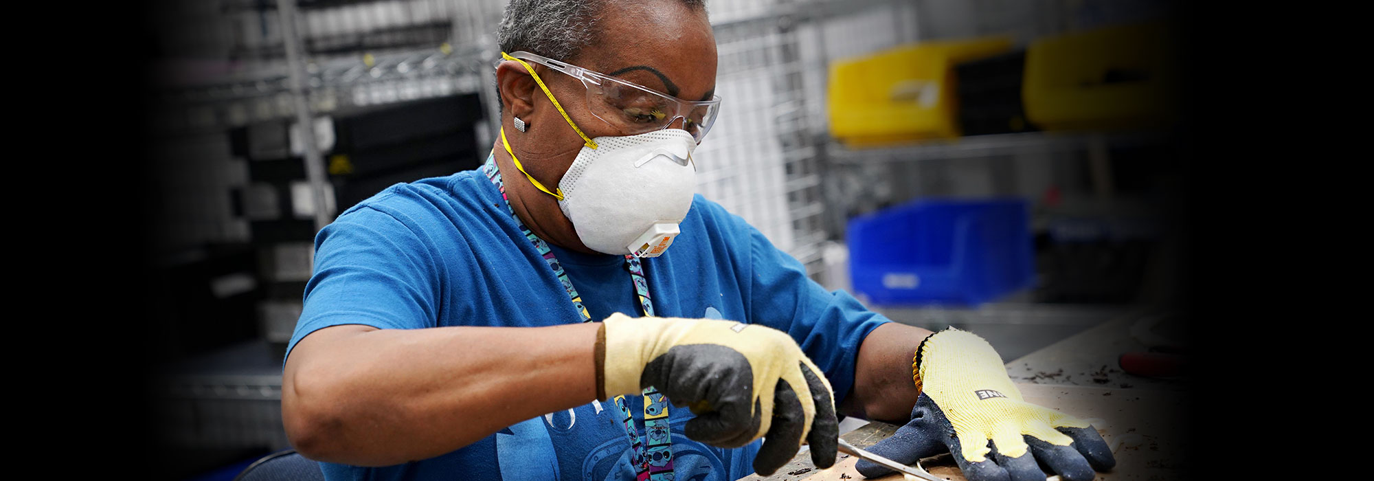 African American woman wearing work gloves and an N95 mask