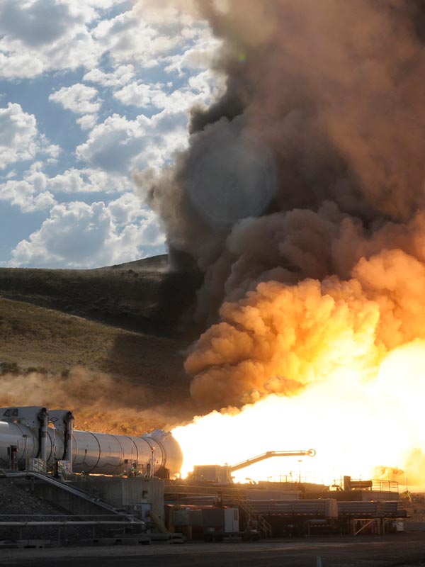 rocket engine laying horizontal and firing in a test scenario