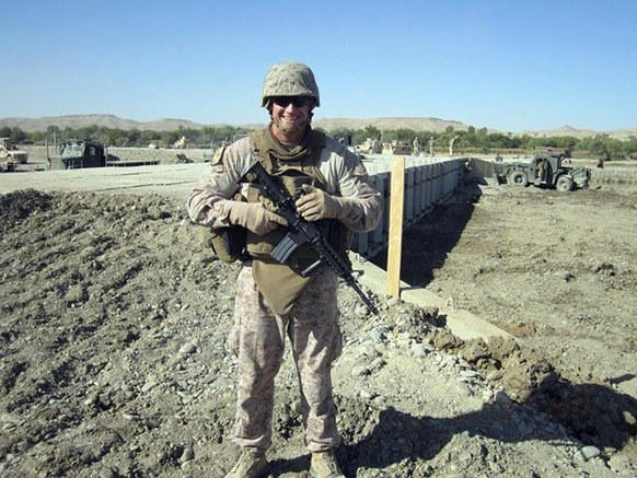 US Marine in uniform holding rifle