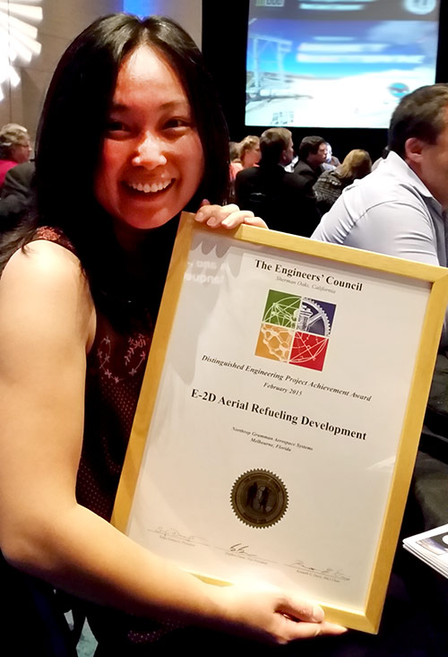 Asian woman holding engineering award