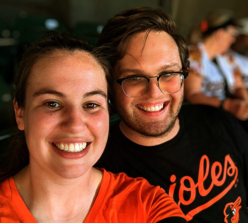 white man and woman at baseball game