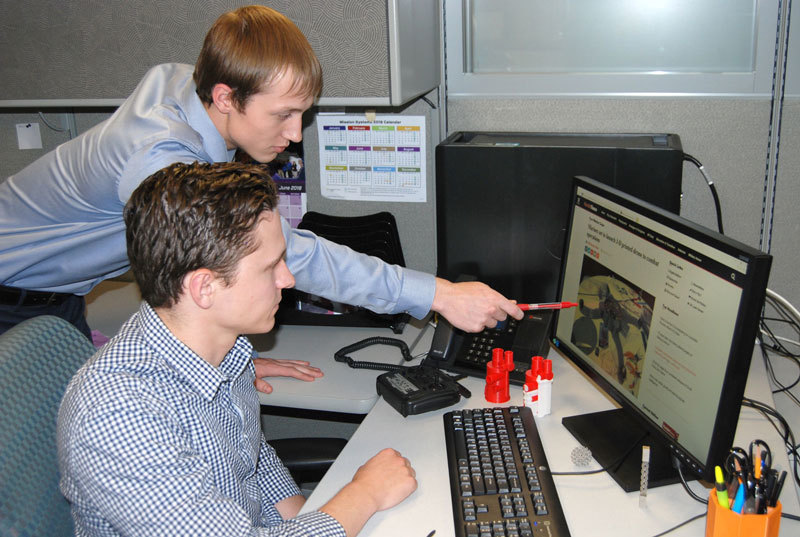 Two Northrop Grumman interns look at a computer together